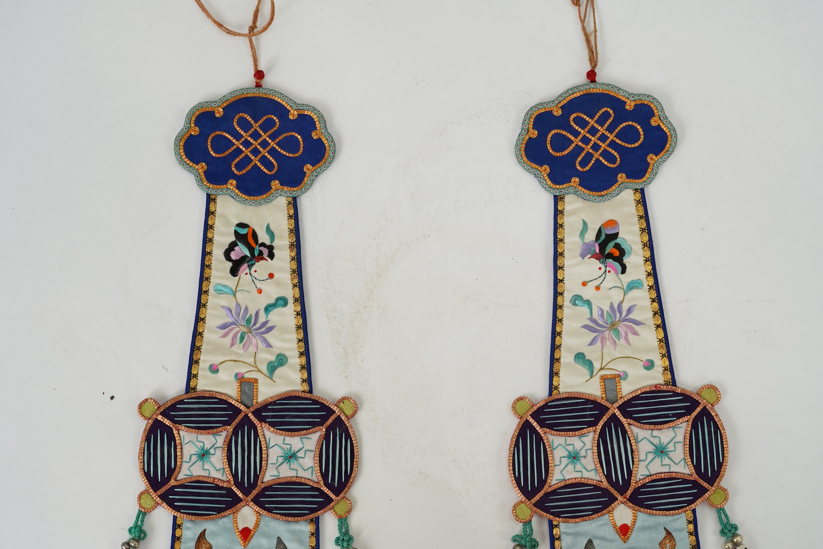 A pair of Chinese embroidered silk hanging pendants, early 20th century
